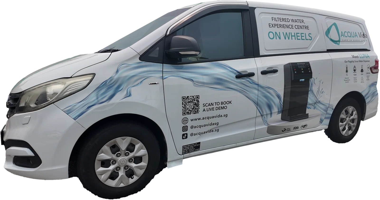 The Acqua Vida mobile showroom van, its side reading 'Filtered Water Experience Centre On Wheels', with the LUNA dispenser printed on the door and a QR code to book a live demo